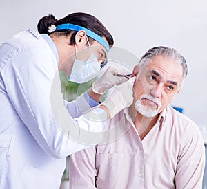 Male patient visiting doctor otolaryngologist