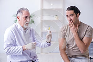 The male patient visitng doctor for shot inoculation