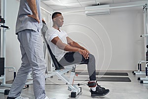 Male patient working out using fitness equipment