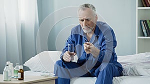 Male pensioner taking daily vitamin complex to maintain genitourinary system