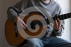 Male performer guitar player, hand focus