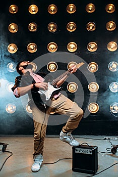 Male performer on stage with decorations of lights