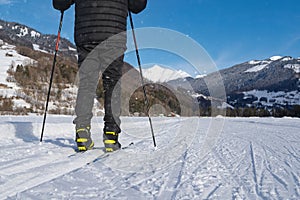 Male person cross-country skiing in beautiful winter landscape in mountains