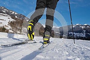 Male person cross-country skiing in beautiful winter landscape in mountains