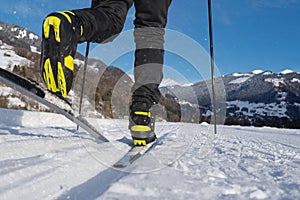 Male person cross-country skiing in beautiful winter landscape in mountains