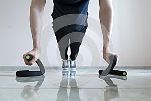 a male person doing push-ups on the floor, making body fit, healthy excersize