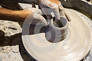 A male person learning pottery