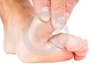 Male person pulling big toe backwards isolated on white