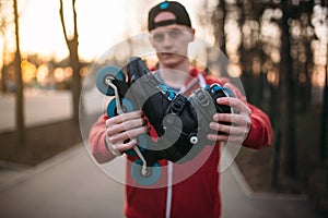 Male person shows roller skates