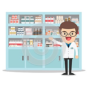 Male pharmacist in a pharmacy opposite the shelves.