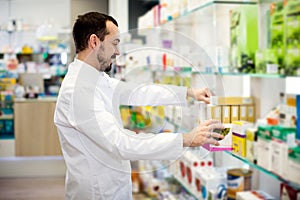 Male pharmacist searching for reliable drug