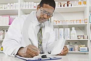 Male Pharmacist Working In Pharmacy photo