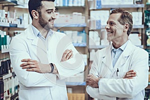 Male pharmacists posing in pharmacy