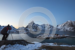 Male photographer captures a twilight landscape at the SakrisÃ¸y Rorbuer in Lofoten, Norway