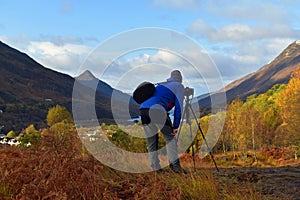 Male photographer with tripod at Kinlochleven, Scottish Highlands