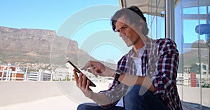 Male photographer using digital tablet outside the stuido 4k