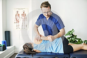 Male Physical Therapist Stretching a Female Patient