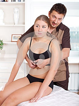 Male physiotherapist doing adjustment