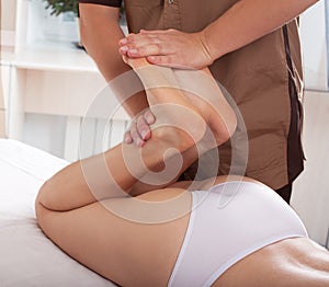 Male physiotherapist or orthopedist doing adjustment