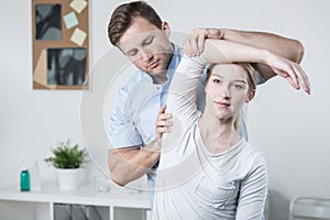 Male physiotherapist training with patient photo