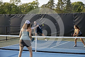 Male Pickleball Player Returns Ball