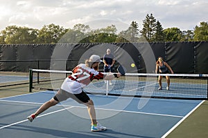 Male Pickleball Player Returns Ball