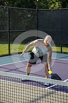 Male Pickleball Player Returns Volley