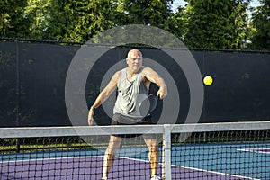 Male Pickleball Player Returns Volley