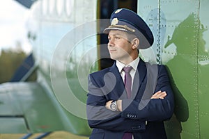 Male pilot near small plane