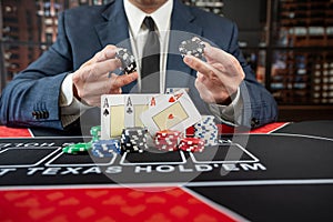 Male player hold poker card play a game for chance to win at casino.