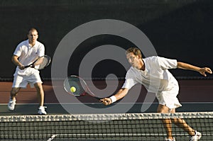 Male Players Playing Tennis