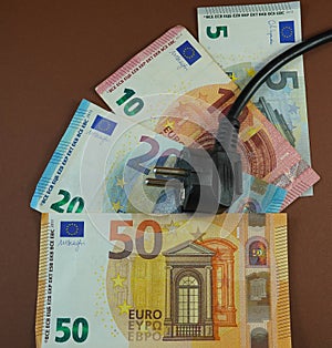 A male plug on banknotes (EUR) photo