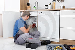 Male Plumber Fixing Sink Pipe