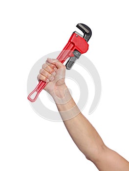 Male plumber holding pipe wrench on background, closeup