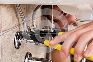 Male Plumber Installing Kitchen Sink