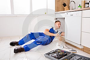 Male Plumber Repairing Sink