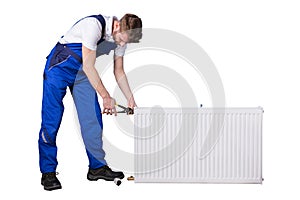 Male Plumber Repairing Thermostat