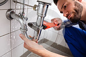 Plumber Repairing Sink Pipe Leakage photo