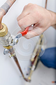 male plumber tightening connection