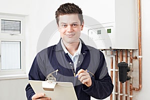 Male Plumber Working On Central Heating Boiler