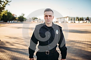 Male police officer in uniform on the road