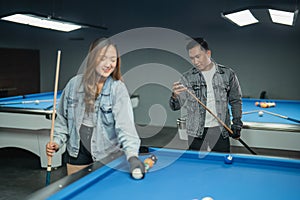 the male pool player gives the chalk at his stick