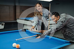 male pool player poking the object ball