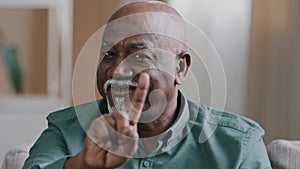 Male portrait old senior mature 60s African American man stretch out palm to camera stop gesture waving head negative