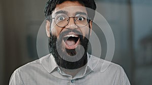 Male portrait surprise emotion enthusiastic surprised shocked arabian amazed man in eyeglasses make big eyes indian