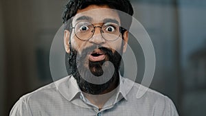 Male portrait surprise emotion enthusiastic surprised shocked arabian amazed man in eyeglasses make big eyes indian