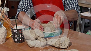 Male potter making ceramic bowl at his workshop