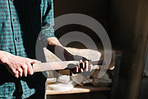 Male potter use rollong pin for clay. Man in workshop