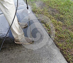 Male Pressure Washing Sidewalk