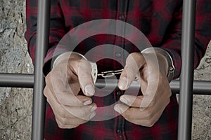 Male prisoner with handcuffs in the jail